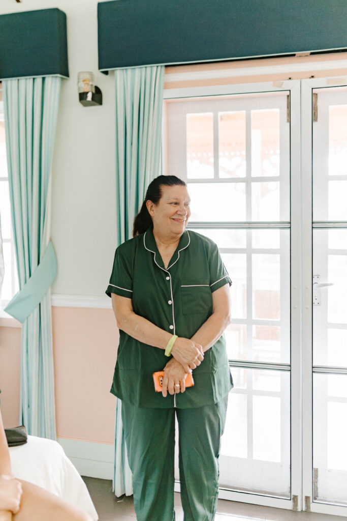 Mother of groom smiles at brides sister getting hair done at La Haut Resort in St. Lucia.