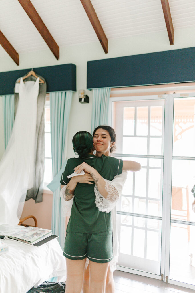 sisters hug on wedding day at La Haut Resort in St. Lucia.