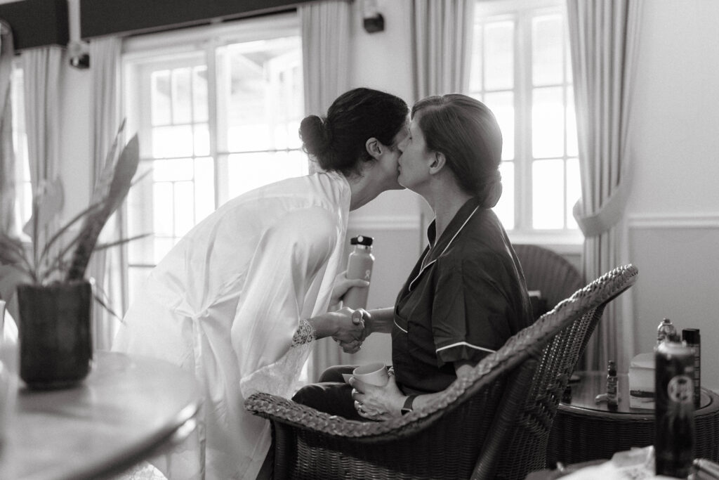 daughter kissing mother on cheek on wedding day at La Haut Resort in St. Lucia.