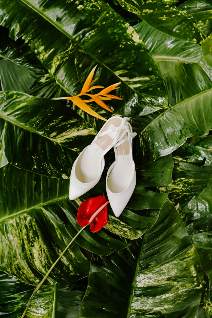 bridal shoes flat lay with floral at La Haut Resort in St. Lucia.