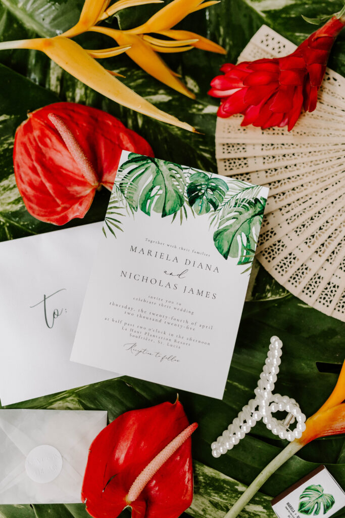 flat lay invitation and accessories with tropical flowers in St. Lucia