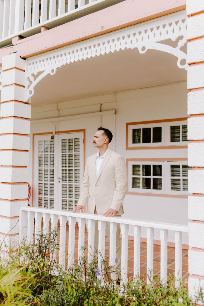 groom looks off in distance before first look with his bride at La Haut Resort in St. Lucia.