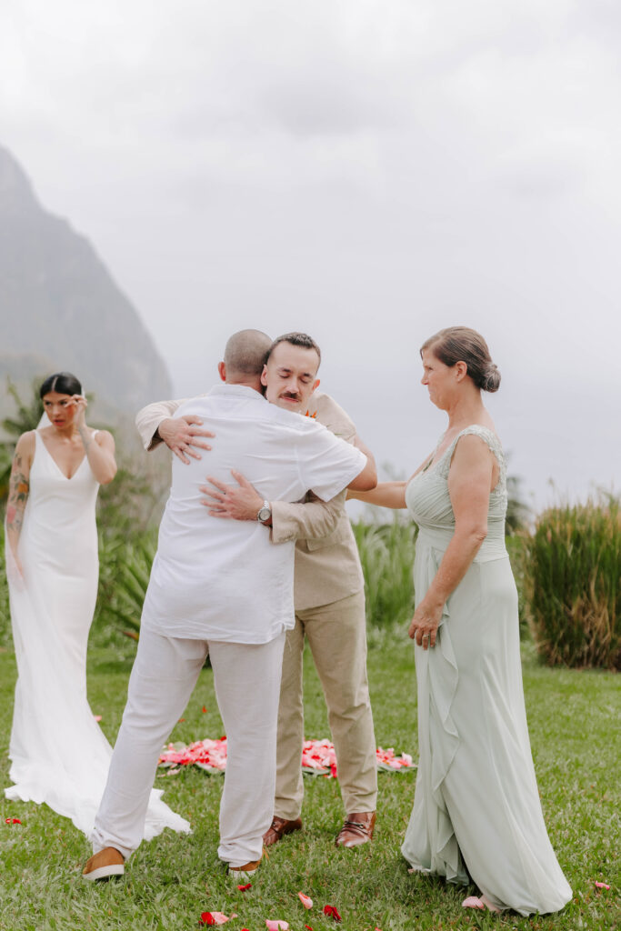 groom hugging parents and givin away bride in st. lucia