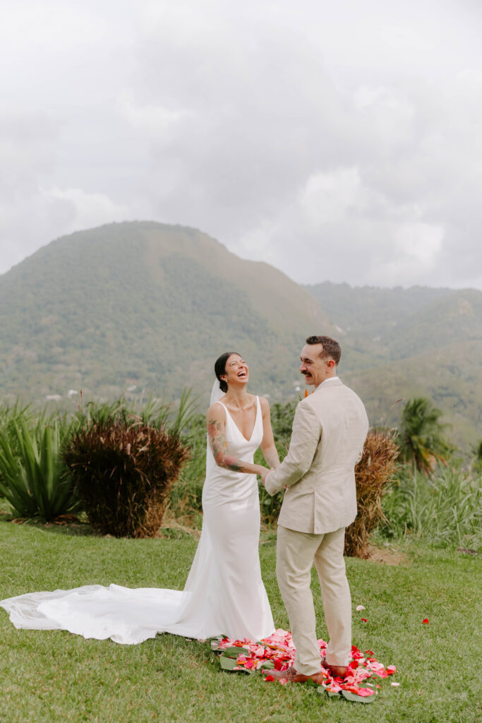 Bride and groom exchanging vows with the Pitons in the background at La Haut Resort in St. Lucia.