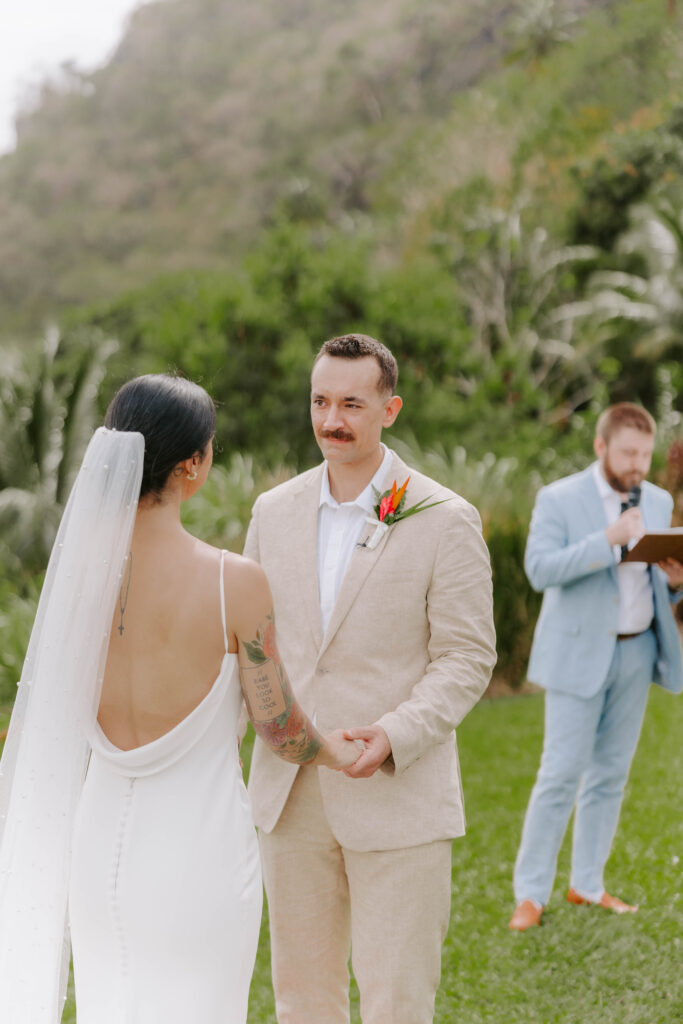 Bride and groom exchanging vows with the Pitons in the background at La Haut Resort in St. Lucia.