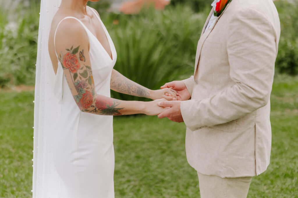 Bride and groom exchanging vows with the Pitons in the background at La Haut Resort in St. Lucia.
