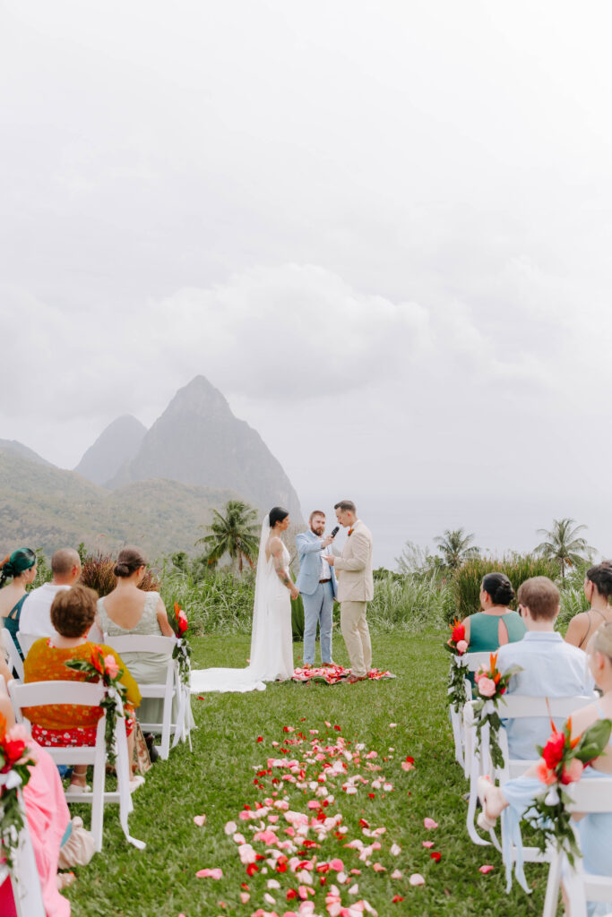 Bride and groom exchanging vows with the Pitons in the background at La Haut Resort in St. Lucia.