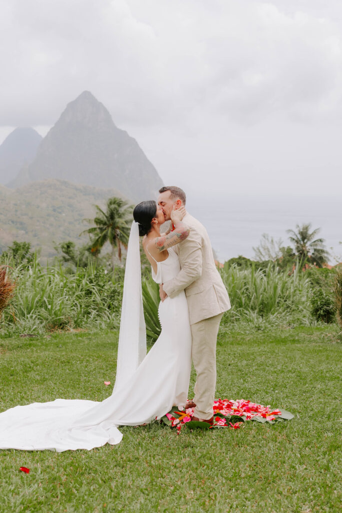 Bride and groom exchanging vows with the Pitons in the background at La Haut Resort in St. Lucia.