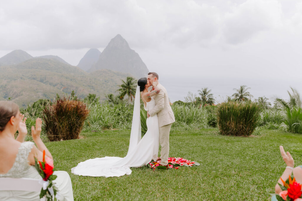 Bride and groom exchanging vows with the Pitons in the background at La Haut Resort in St. Lucia.