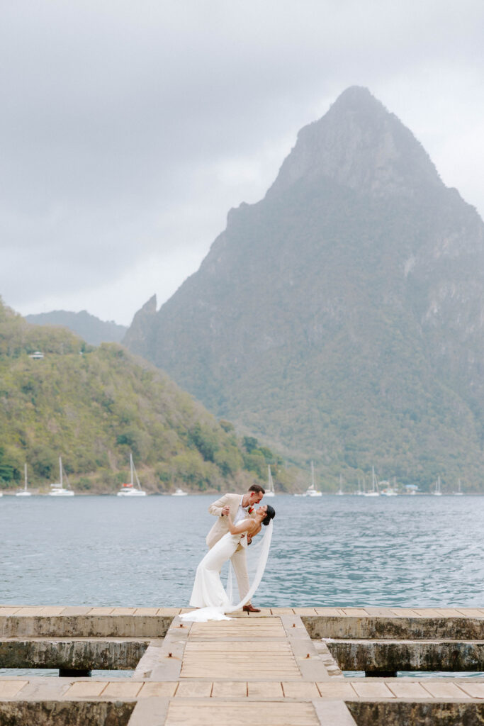 couples wedding day portraits dipping on beach in Soufriere, St. Lucia