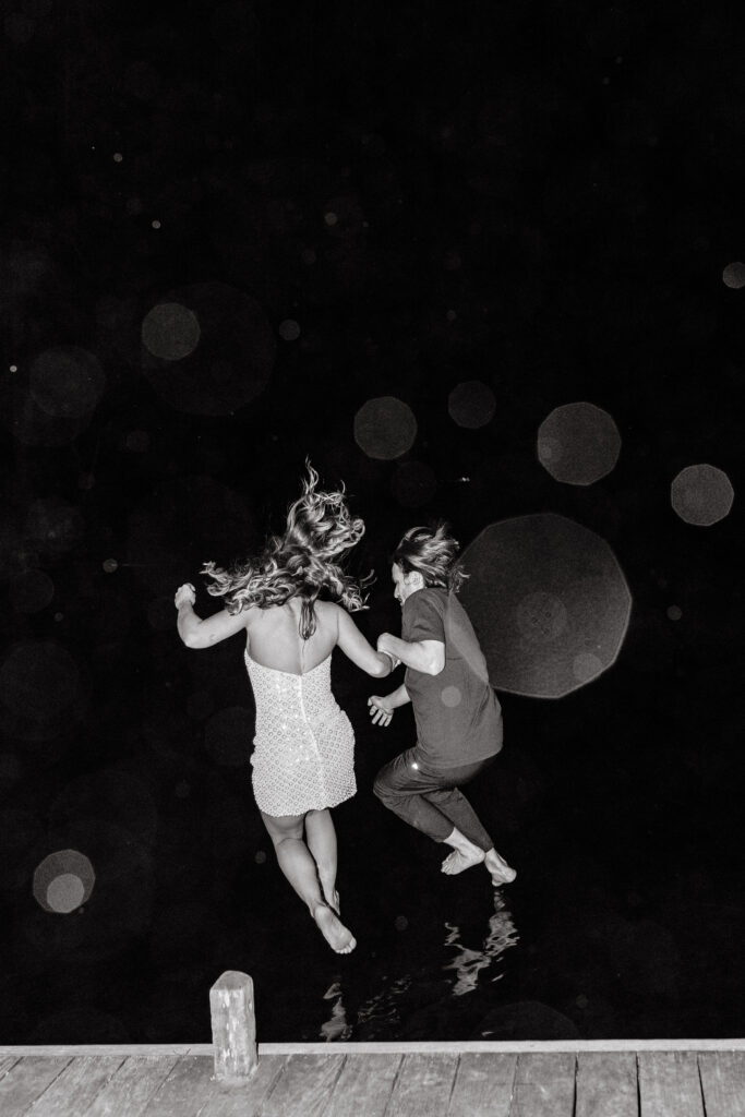 Bride and groom jumping in Sebago lake post 