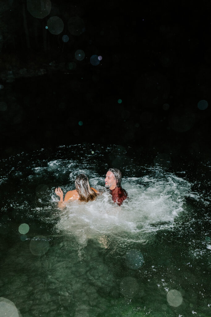Bride and groom jumping in Sebago lake post ceremony