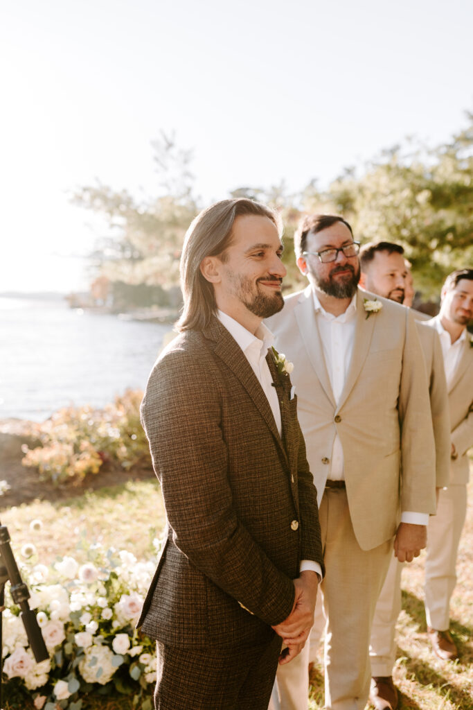 Wedding ceremony at Migis lodge lawn on Sebago lake, Maine