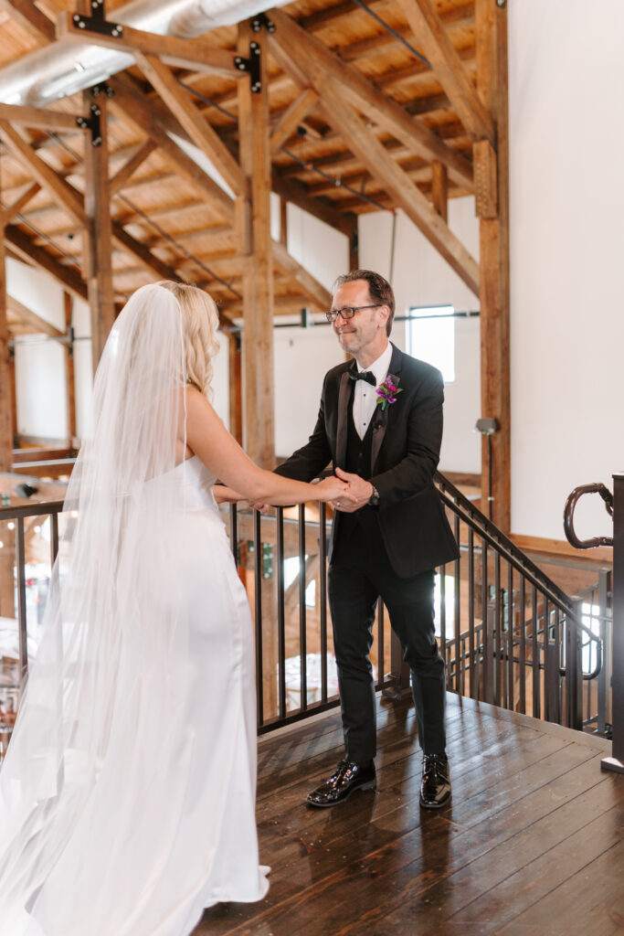 Bride does first look with father at wedding.