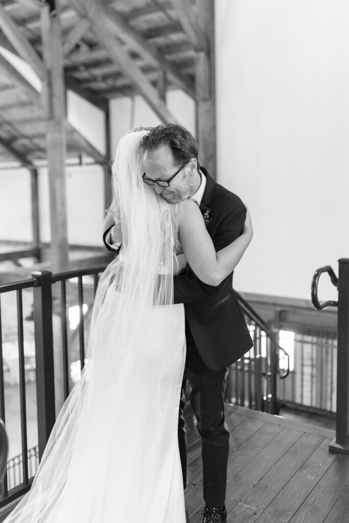 Bride does first look with father at wedding.