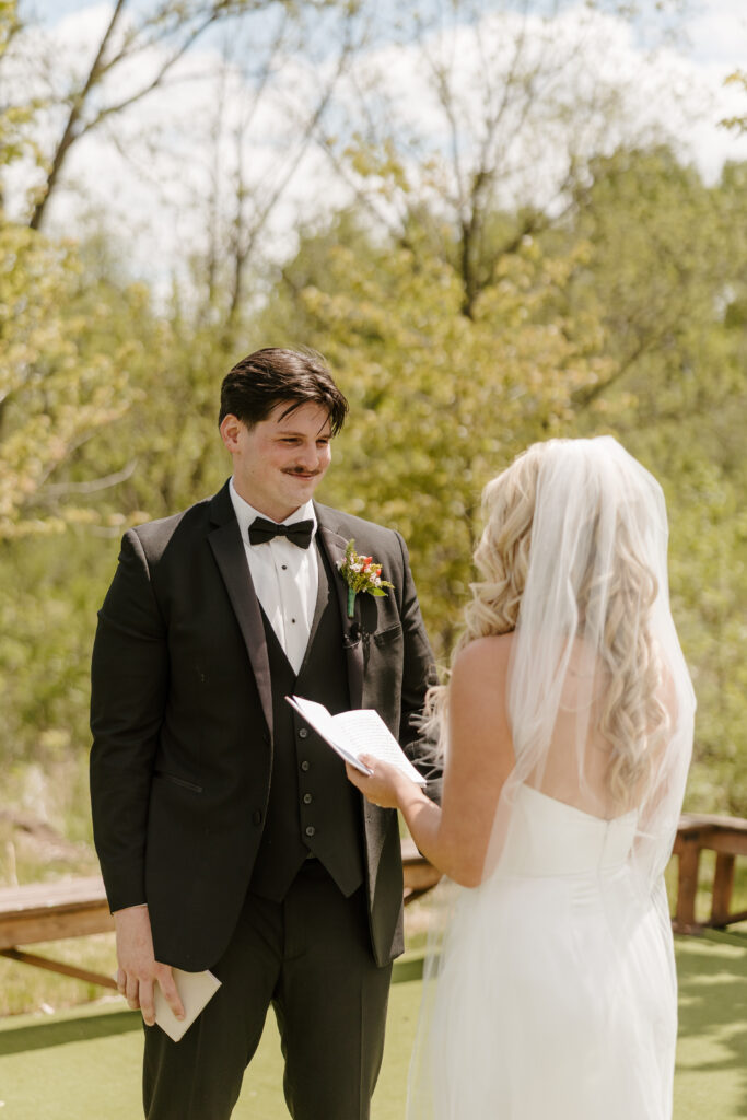 Bride and groom exchange vows at The Barn at Timber Pointe venue in Chicago, IL.