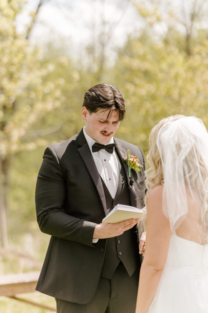 Bride and groom exchange vows at The Barn at Timber Pointe venue in Chicago, IL.