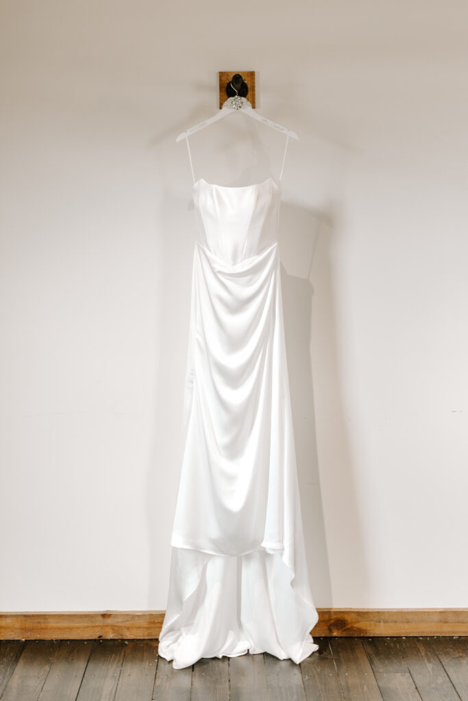 wedding dress hung up on wall