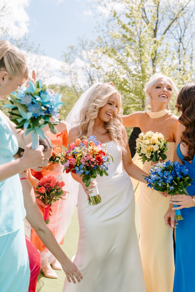Bride laughs with bridesmaids before wedding ceremony in Chicago IL.