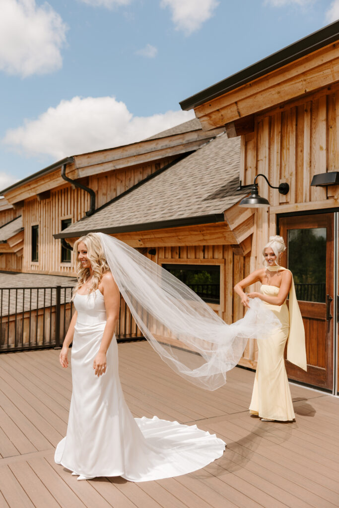 Bride does first look with wedding party at The Barn at Timber Pointe in Chicago, IL.