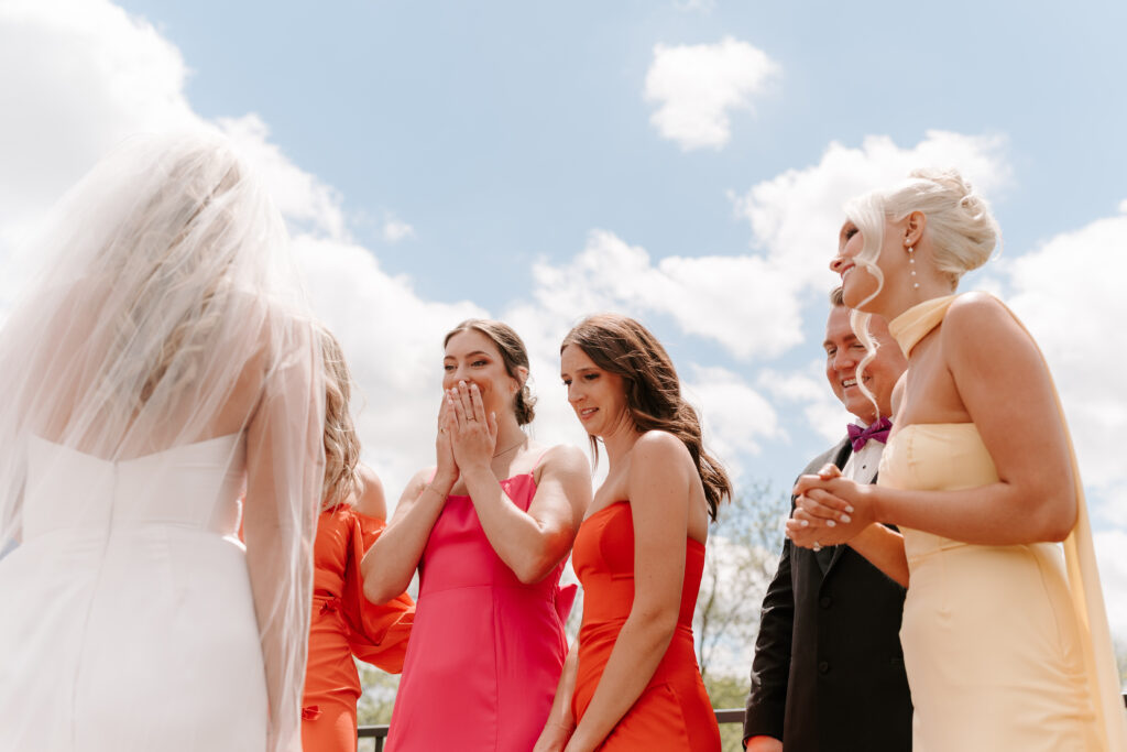 Bride does first look with wedding party at The Barn at Timber Pointe in Chicago, IL.