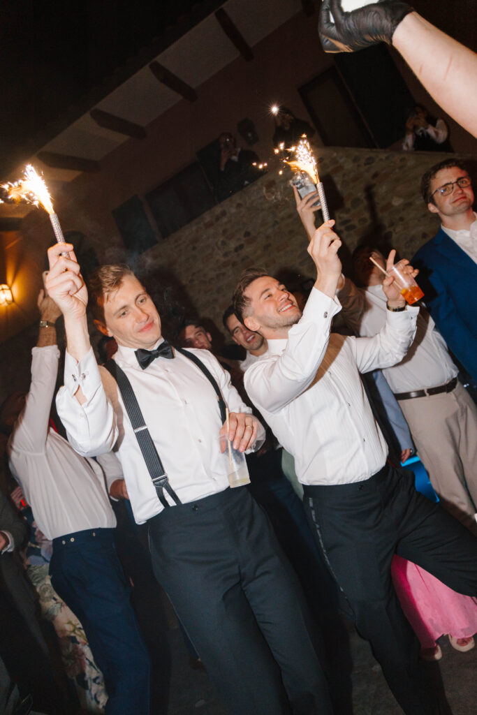 Grooms dance at wedding reception in Tuscany