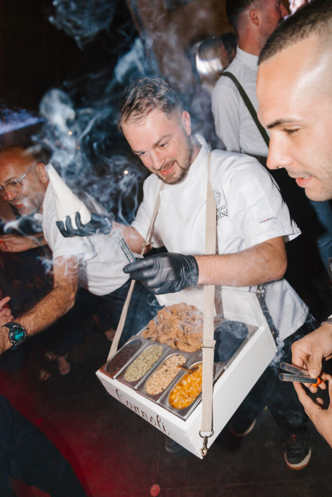 Canoli man shares canoli with wedding guests at reception in Tuscany Italy