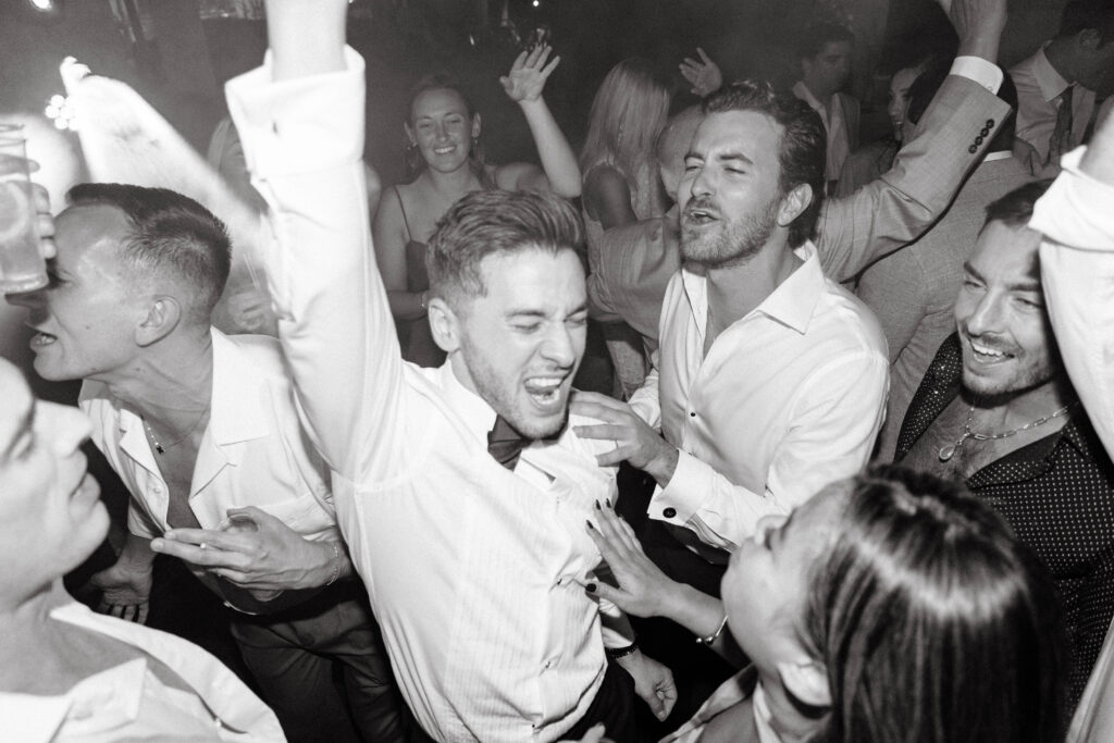Groom dances on dance floor in Tuscany