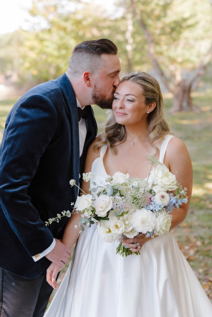 omantic couple portrait under the trees at The Point on Great Diamond Island
