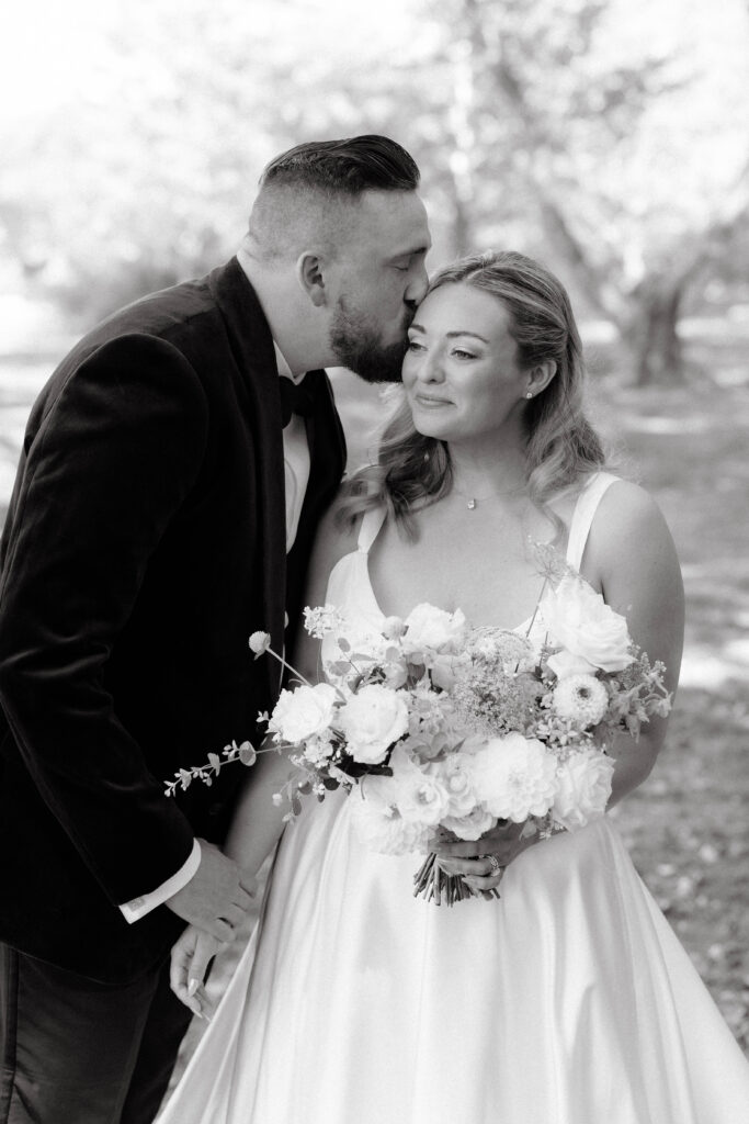 omantic couple portrait under the trees at The Point on Great Diamond Island