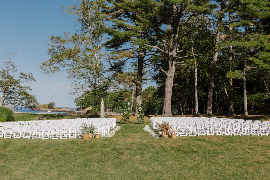Elegant floral arrangements lining the aisle for a Great Diamond Island wedding ceremony