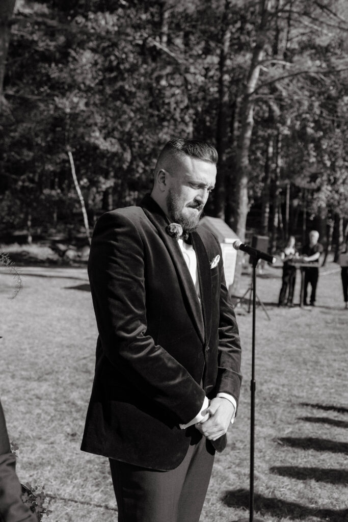Groom reaction to bride walking down isle at wedding ceremony