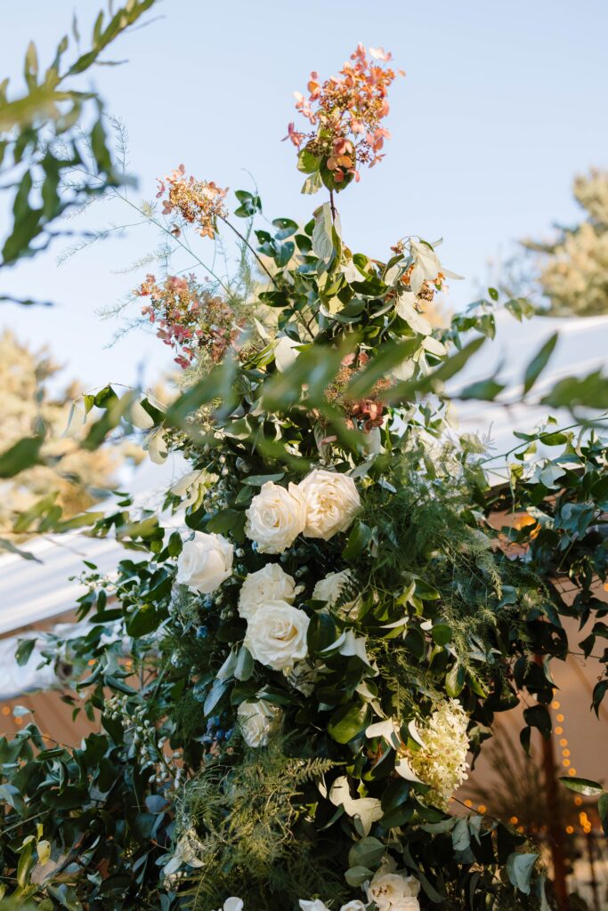 Elegant floral arbor welcoming guests into the tented Great Diamond Island wedding reception