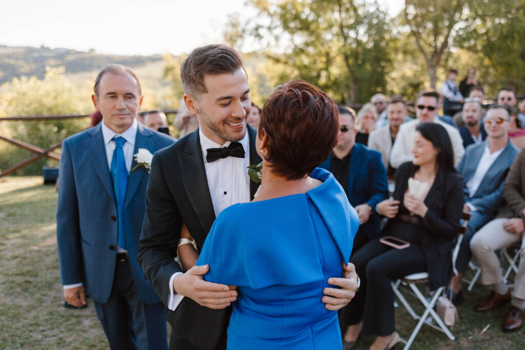 Groom hugs mom on wedding day
