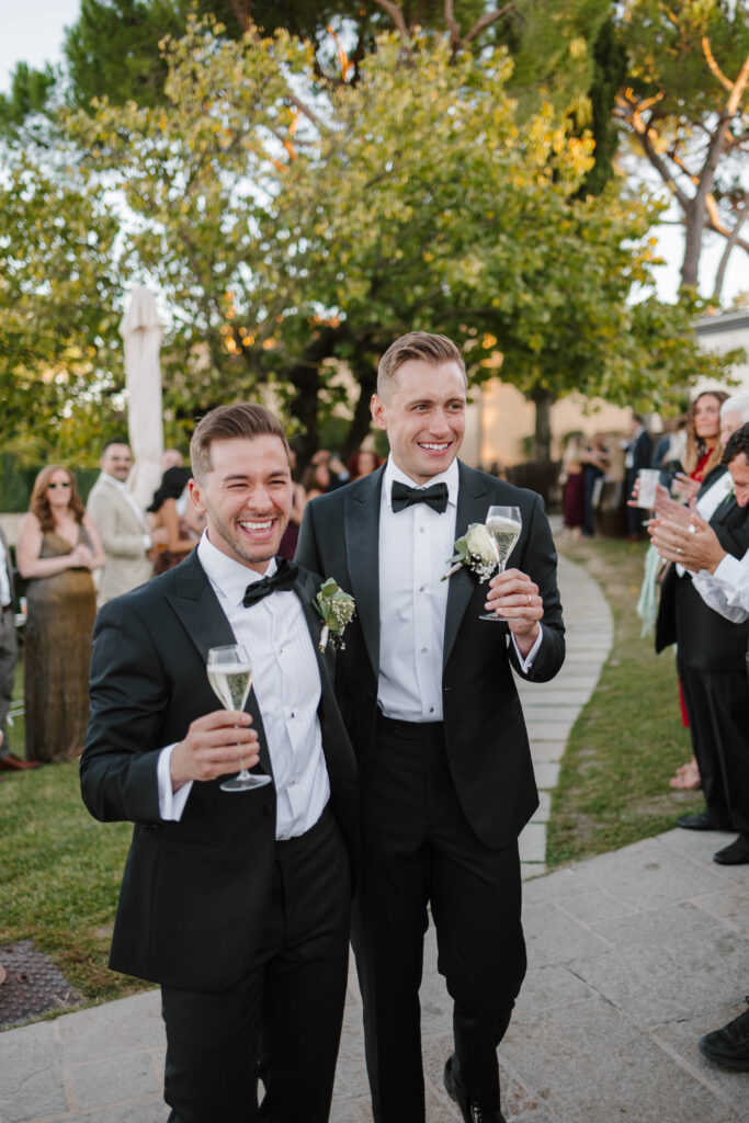 Grooms cheer and celebrate marriage at wedding in Tuscany