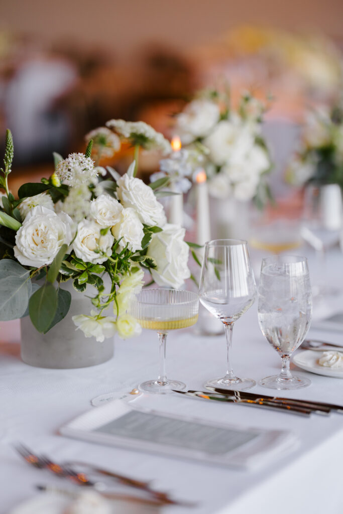 Wedding floral arrangements on table at wedding reception.