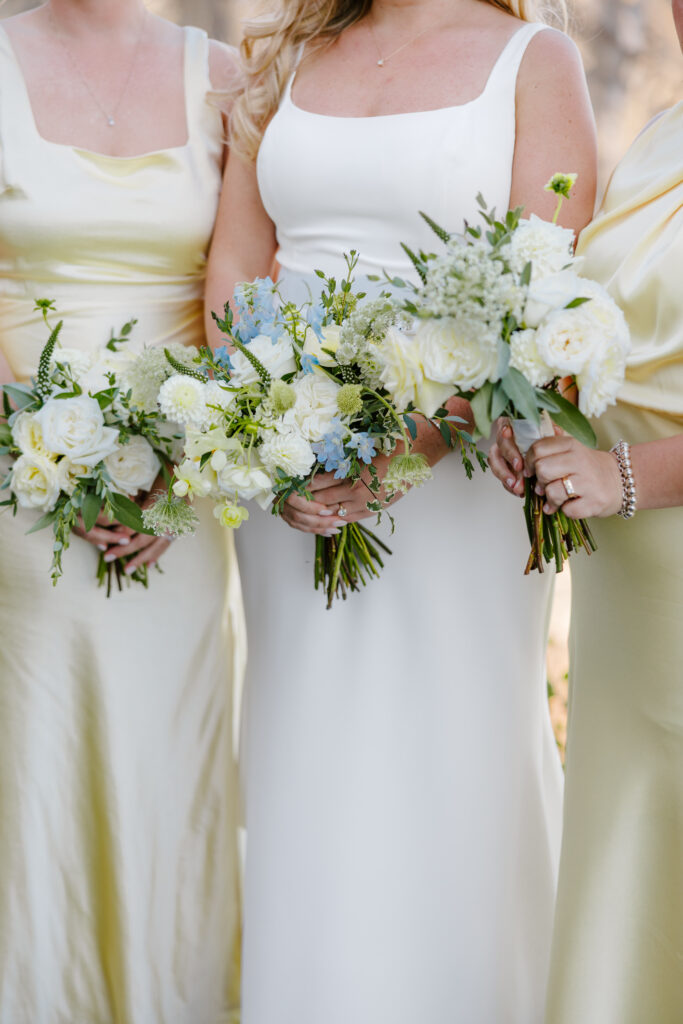 Bridesmaids bouquets with yellow and blue at Cliff House, Maine.