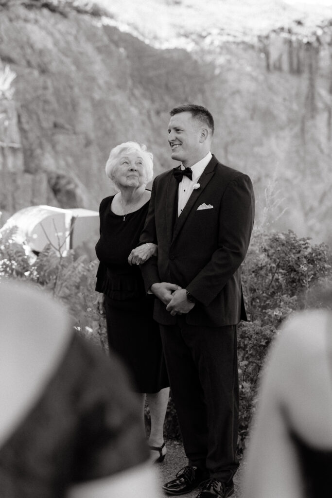 Grandmother glances at groom for wedding portrait in Maine.