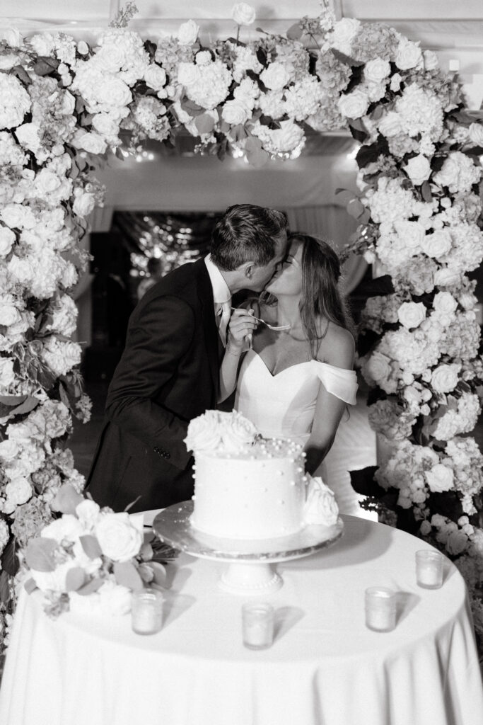 bride and groom cut cake at wedding in newport at regatta place