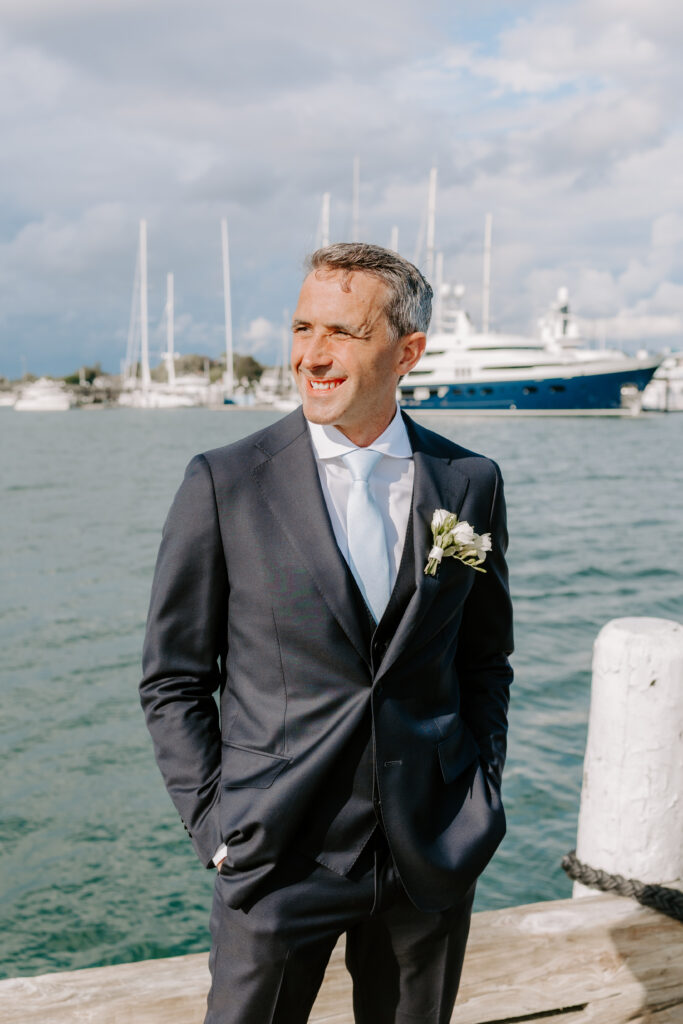 Bride and groom at Regatta Place during summer wedding ceremony overlooking Newport harbor