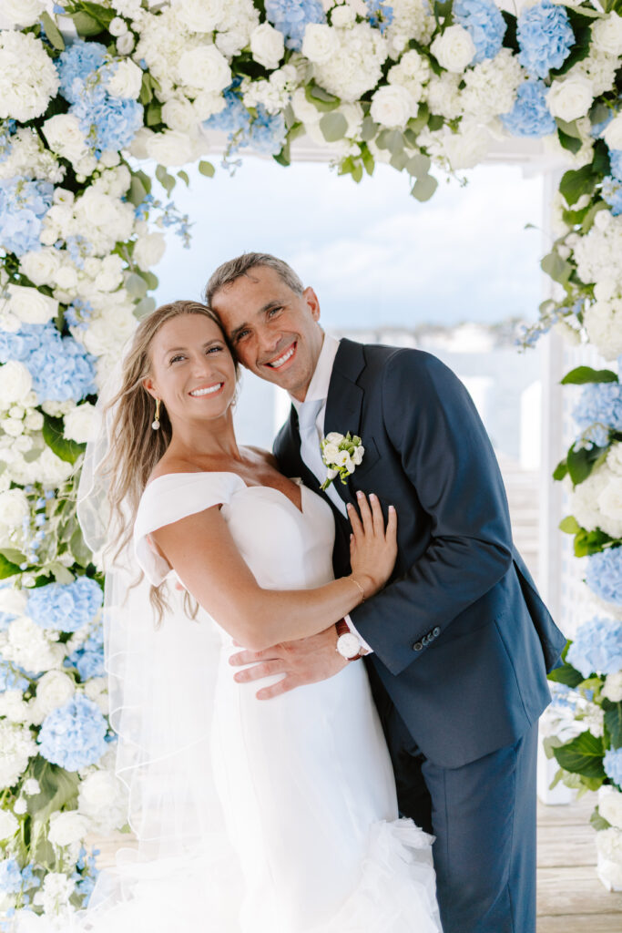 Bride and groom at Regatta Place during summer wedding ceremony overlooking Newport harbor