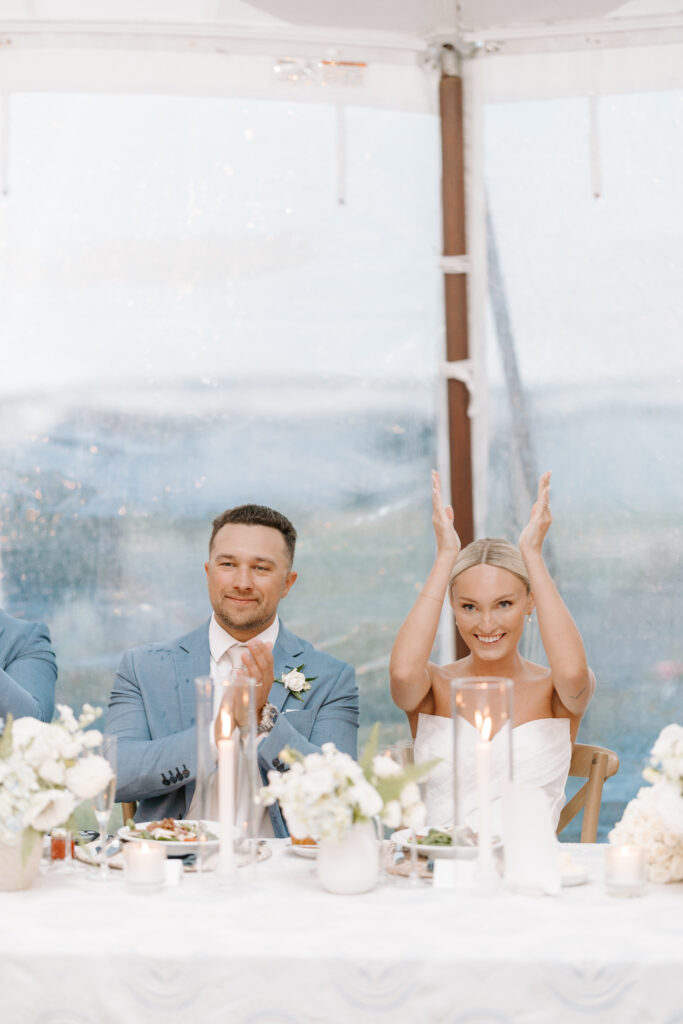 bride cheers during speeches at reception in maine at the samoset resort
