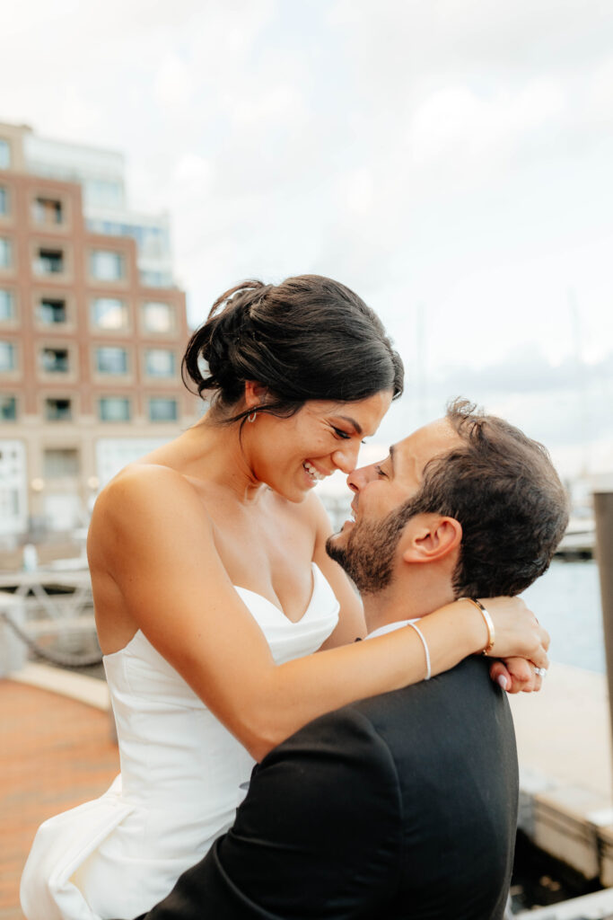 bride and groom smile at each other on wedding day in boston