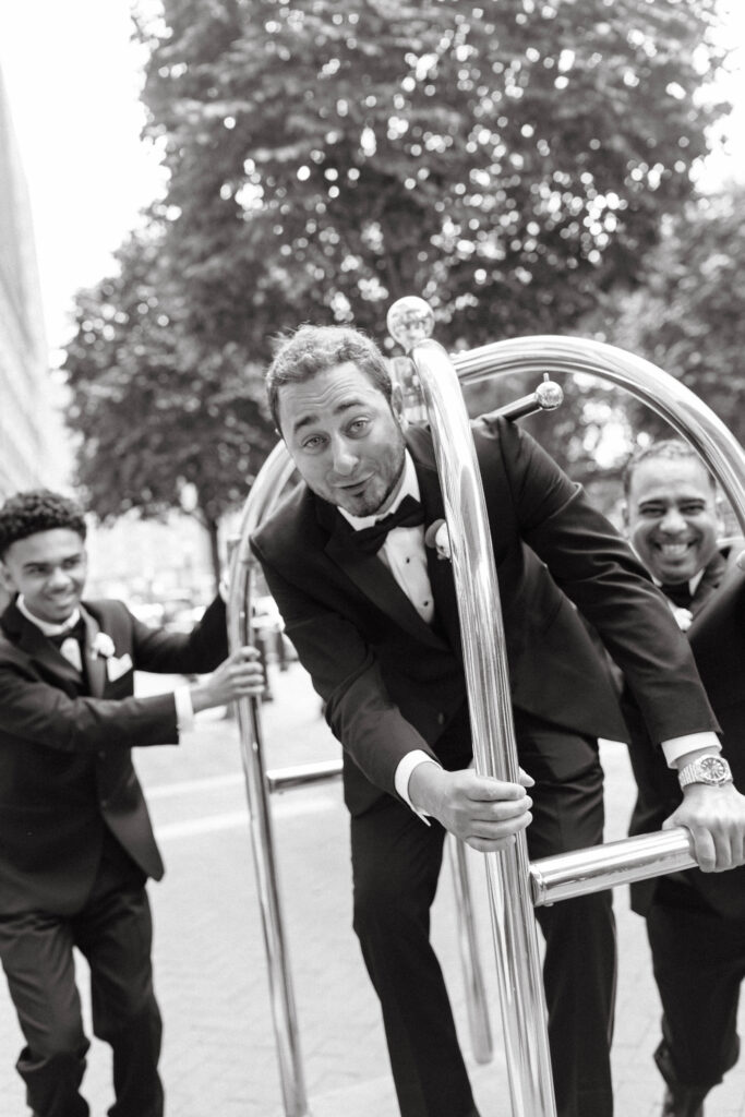 groom has fun at wedding day at boston harbor hotel