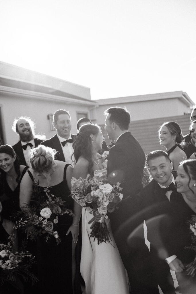 wedding party cheers for bride and groom at the lakehouse in halifax massachusetts