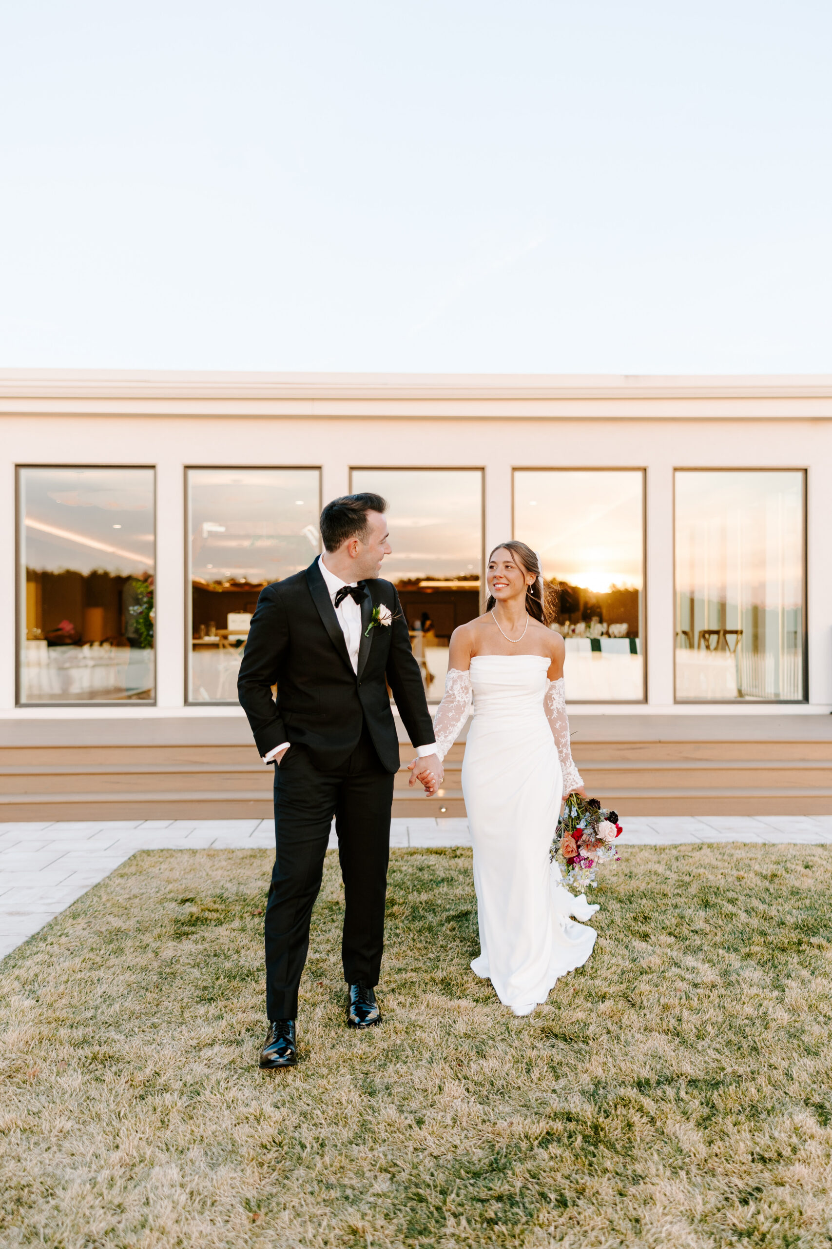 bride and groom walk together at the lakehouse in halifax massachusetts