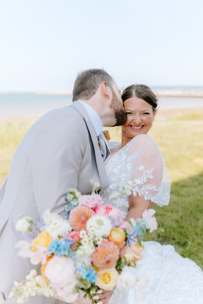 groom and bridal portrait with beautiful pastel bouquet