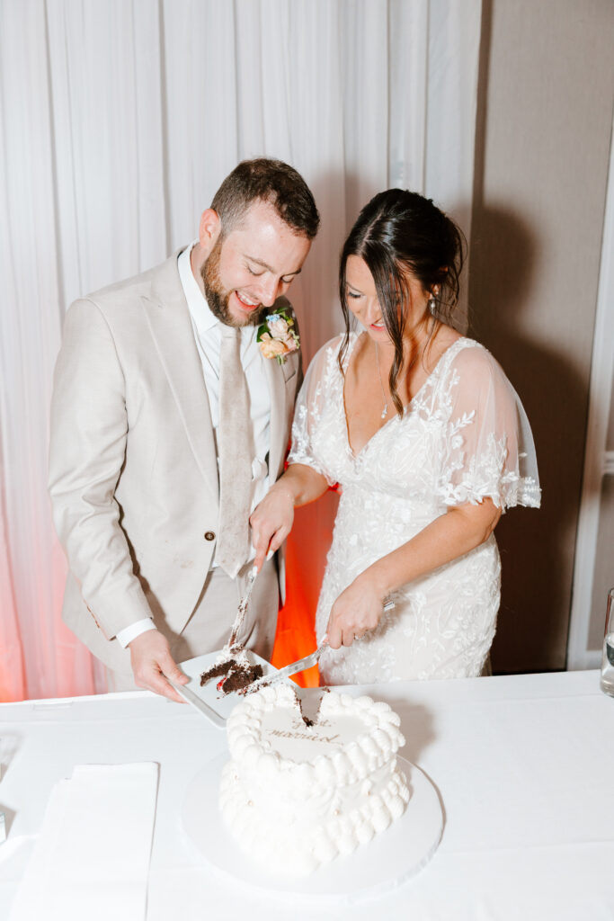 bride and groom cut wedding cake