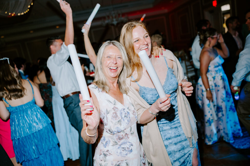 wedding guests smile and dance at wedding reception