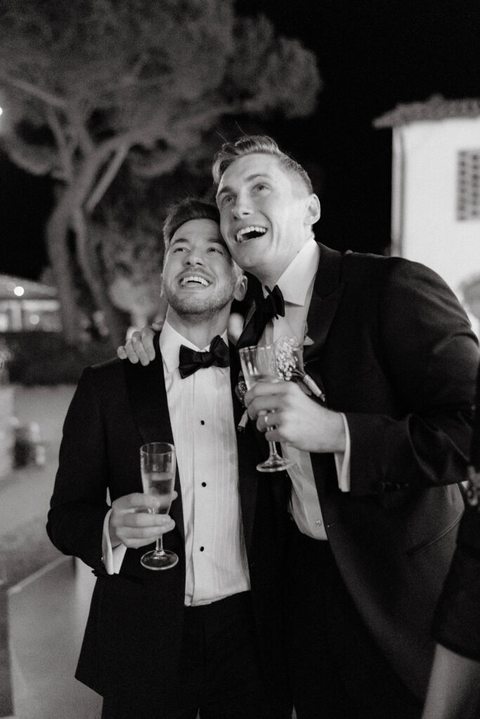 grooms celebrate with each other at wedding reception